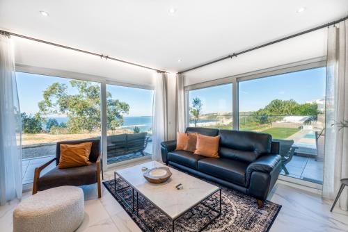 a living room with a couch and a table at Mar a Vista - Condominium with Pool, Gym and Sea Views in Nazaré