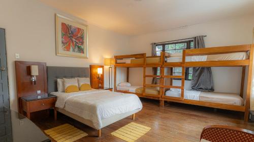 a bedroom with two bunk beds and a bed at Finca Escalante in San José