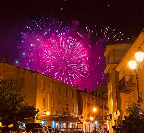 a firework display in a city at night at Hotel Restaurant L'Europe in Saint-Florent