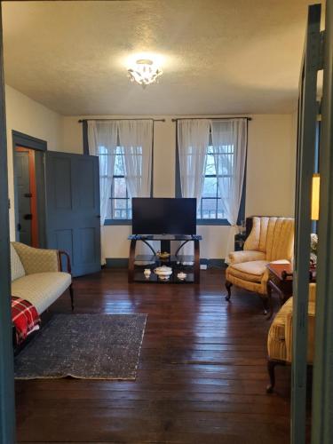 a living room with a couch and a tv at Baneberry Meadows B&B in Donegal