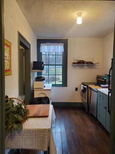 a kitchen with a table and a window at Baneberry Meadows B&B in Donegal