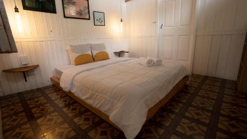 a bedroom with a large bed with two towels on it at awā San José in San José