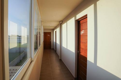 pasillo de un edificio con ventana en Solana - Apart Hotel & Club de Tenis en Santa Clara del Mar