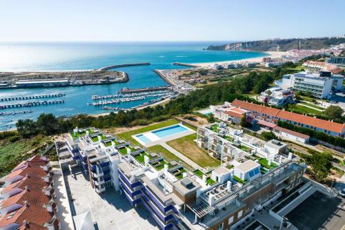 an aerial view of the city and the ocean at Mar a Vista - Condominium with Pool, Gym and Sea Views in Nazaré