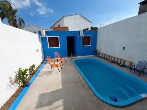 a swimming pool on the side of a house at Pousada Recanto do Coruja in São Gabriel