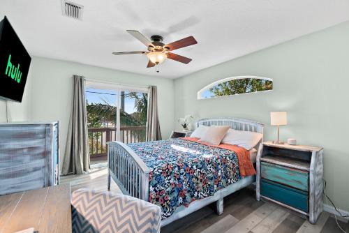 a bedroom with a bed and a ceiling fan at Beachside Serenity Escape - Private 3BR and 2BA, DOG FRIENDLY Duplex Oasis, Steps to Shore! in Melbourne
