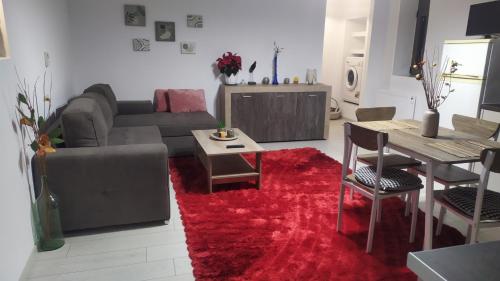 a living room with a couch and a red rug at Aelia in Agios Vlasios