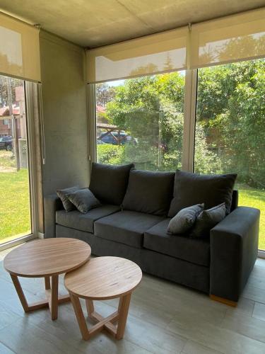 a living room with a couch and two tables at Complejo 42 in Mar Azul