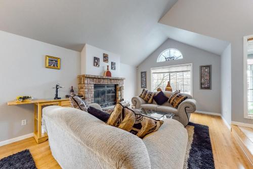 a living room with two couches and a fireplace at Lord Manor in Windsor