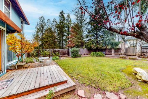 a backyard with a wooden deck and a fence at Lord Manor in Windsor