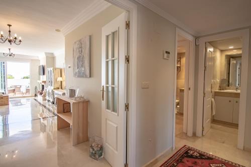 een woonkamer met een deur naar een keuken bij Ático familiar con terraza y bonitas vistas al mar en Marbella - Rio Real 282G in Marbella