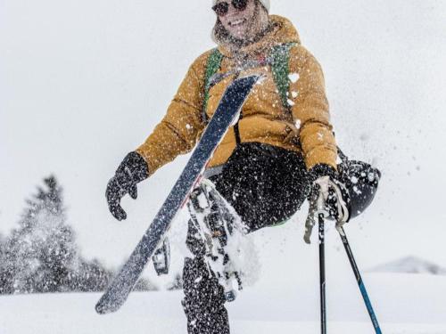 a man is jumping in the snow with skis at Pöchtlhof in Leogang