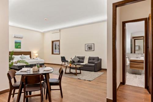 a living room with a table and a couch at Casa Herrmann Suites in Mexico City