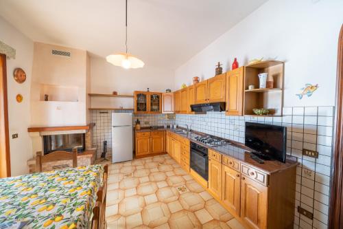 a kitchen with wooden cabinets and a counter top at Il Rifugio Del Merlo in Amalfi
