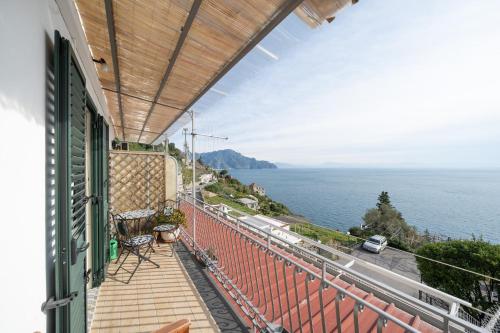 a balcony of a house with a view of the ocean at DACHI HOLIDAY HOUSE in Amalfi