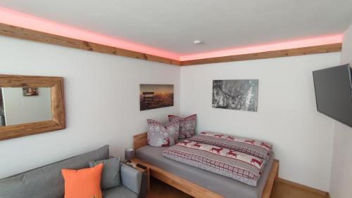 a bedroom with a bed and a couch at Fewo Gabriela Allgäu in Immenstadt im Allgäu