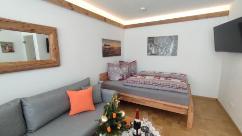 a living room with a couch and a christmas tree at Fewo Gabriela Allgäu in Immenstadt im Allgäu