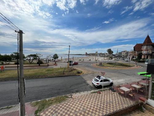 a white car parked on the side of a street at Gran Colonial Riviera in Piriápolis