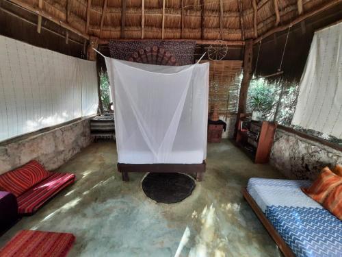 a room with a bed and a net in it at Toto Aiko in Tulum