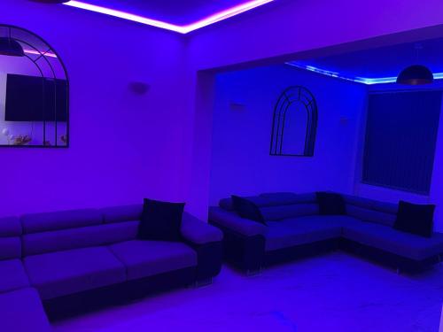 a living room with purple lights and couches at Short Stopzzz & Indoor Hot Tub in Manchester