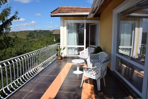 einen Balkon mit zwei Stühlen und einem Tisch darauf in der Unterkunft Vila Sofia in Warna