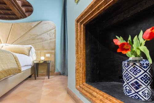 a vase with red flowers in a room at Residenza Spada in Rome