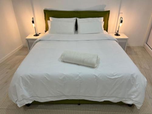 a large white bed with a white pillow on it at MiMo da Sé in Bragança