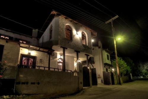 a building with lights on the side of it at night at Chateaux Constantin Agistro in Ángistron