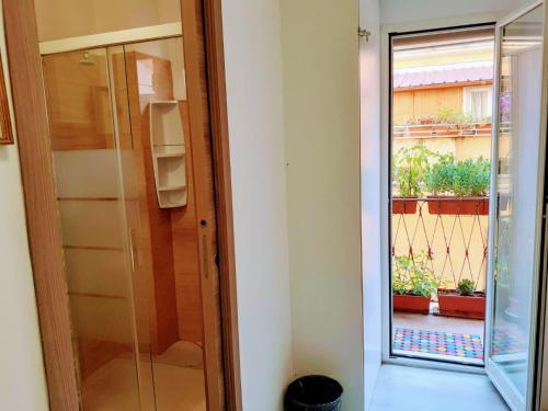 a glass door leading to a balcony with plants at Napoleone Luxury Home roma in Rome