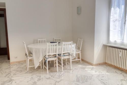 a dining room with a white table and chairs at Da Jo! in Chiavari