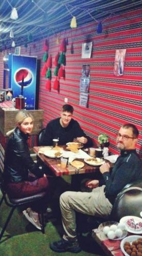 a group of three people sitting at a table at Majido Hotel in Wadi Musa