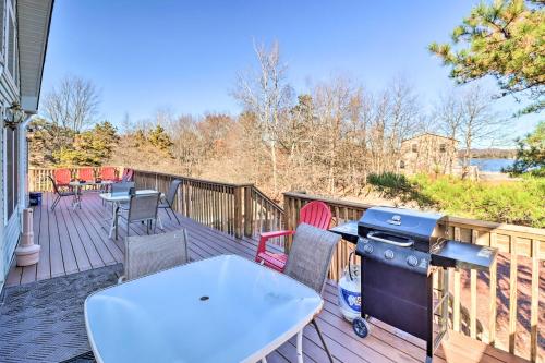 a grill on a deck with chairs and a table at Near Hiking Lakefront Albrightsville Home with Deck in Albrightsville