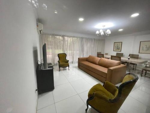 a living room with a couch and chairs and a table at Amplia Casa cerca de Aristdes con Patio y Parilla in Mendoza