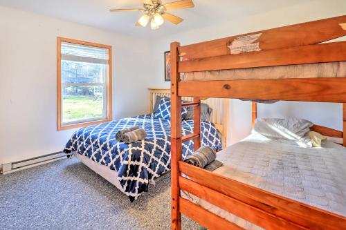 a bedroom with two bunk beds and a ceiling fan at Near Hiking Lakefront Albrightsville Home with Deck in Albrightsville