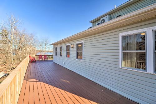 a wooden deck on the side of a house at Near Hiking Lakefront Albrightsville Home with Deck in Albrightsville