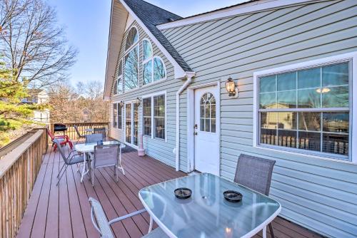 a patio with a table and chairs on a deck at Near Hiking Lakefront Albrightsville Home with Deck in Albrightsville