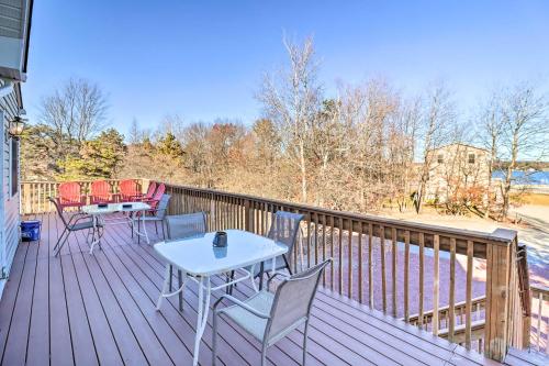 a deck with a table and chairs on it at Near Hiking Lakefront Albrightsville Home with Deck in Albrightsville