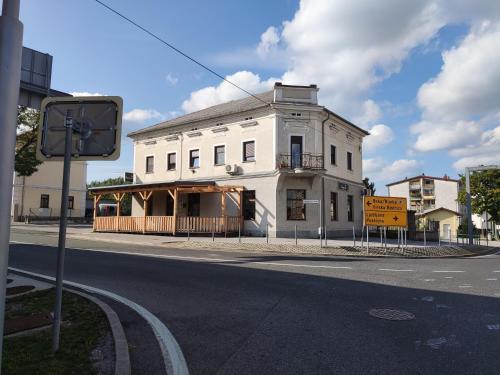 a white building on the corner of a street at Family Hostel Pivka in Pivka