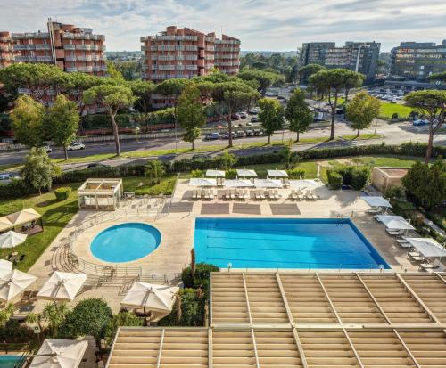 an overhead view of a pool with chairs and umbrellas at Holiday Inn Rome - Eur Parco Dei Medici, an IHG Hotel in Rome