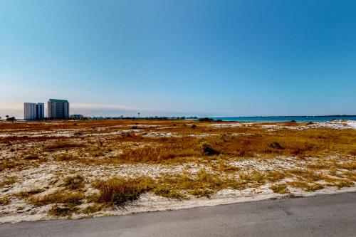 a field of grass with buildings in the background at Gulf Island 412 in Navarre