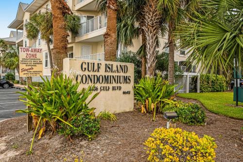 a sign in front of a building with palm trees at Gulf Island 412 in Navarre
