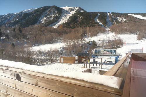 a view of a snow covered mountain from a deck at CASTEL ISARD - Le Refuge in Porté-Puymorens