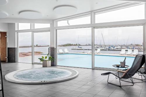 a large room with a pool with a view of a harbor at Best Western Hotel Corallen in Oskarshamn
