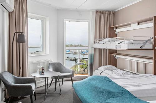 a hotel room with a bed and a table and chairs at Best Western Hotel Corallen in Oskarshamn