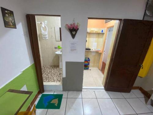 pasillo con baño con aseo y puerta en Mini Suite Independiente en Garzota Norte, en Guayaquil
