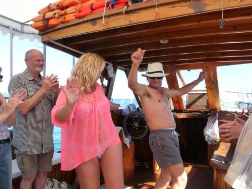 a man and a woman standing on a boat at Beach House Hotel in Side