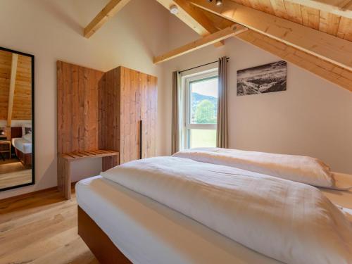 a bedroom with a large bed and a window at Mountain Vista in Sankt Lorenzen ob Murau