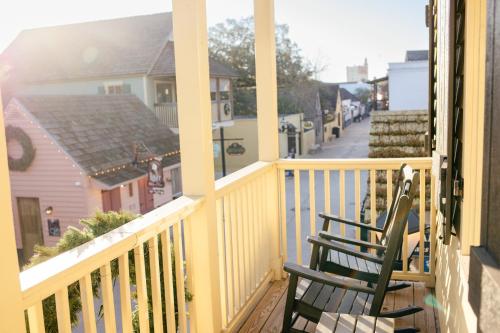 two chairs sitting on a balcony of a house at 14 1/2 St. George Street in St. Augustine