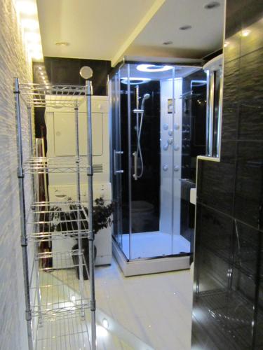 a walk in shower in a bathroom with a glass door at Villa Baneheia in Kristiansand