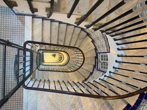 a spiral staircase in a building with a window at AFRIC HOTEL- Casbah in Alger